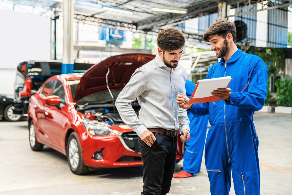 Bridgeton GMC service advisor discussing car repair with customer in service center