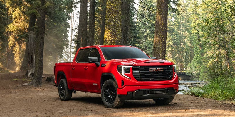 2026 GMC Sierra 1500 parked outdoors near forest view